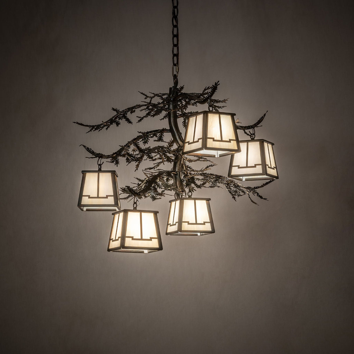 Ambient view of 5 light chandelier illuminated in a room setting.