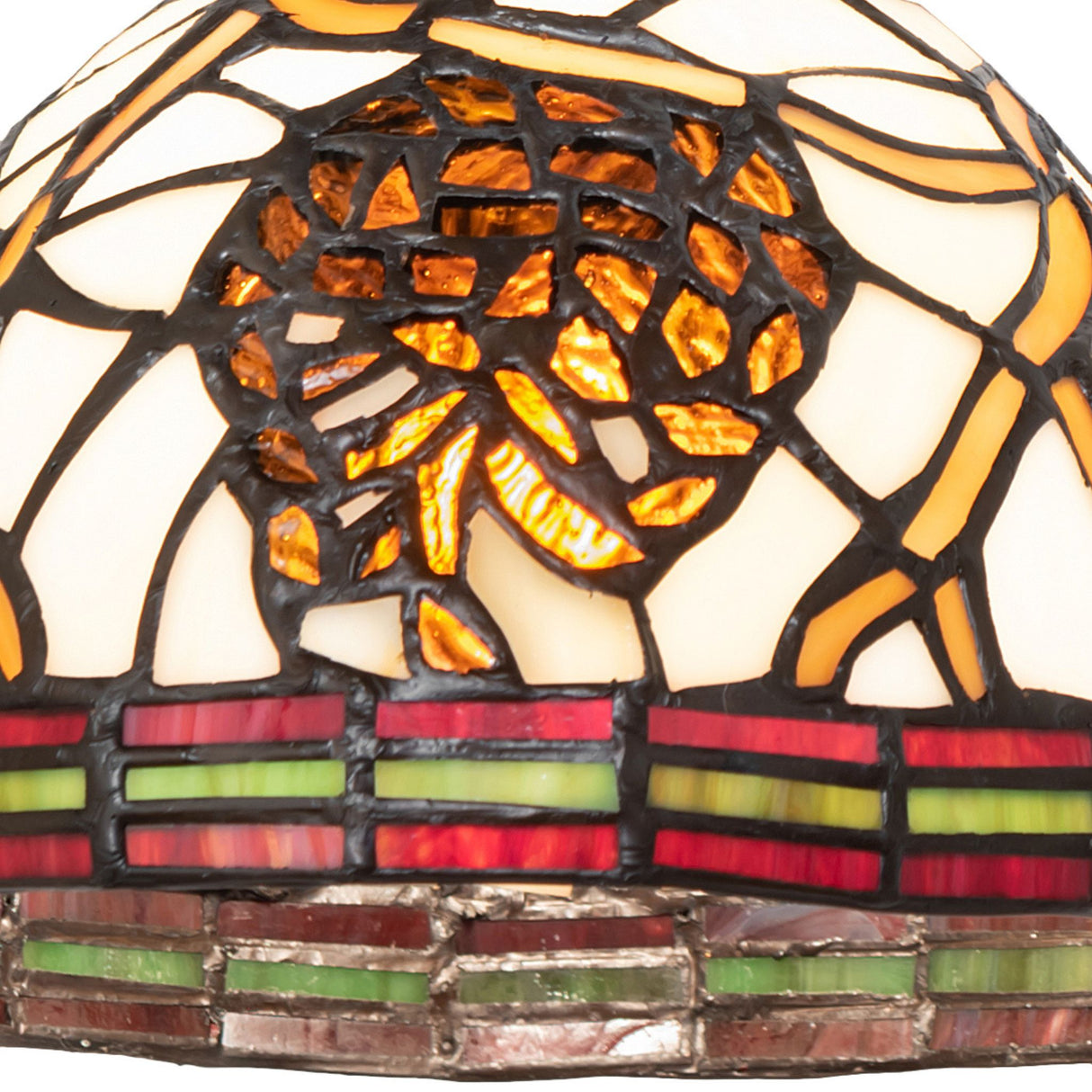 Pattern detail on the glass shade with natural pinecone elements.