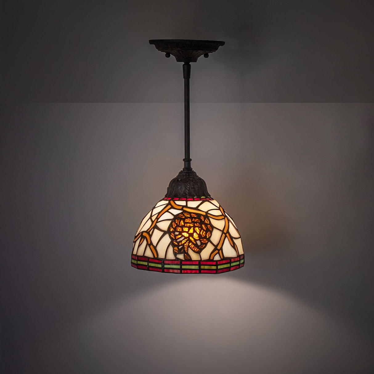 Pinecone mini pendant illuminated in a modern room setting.
