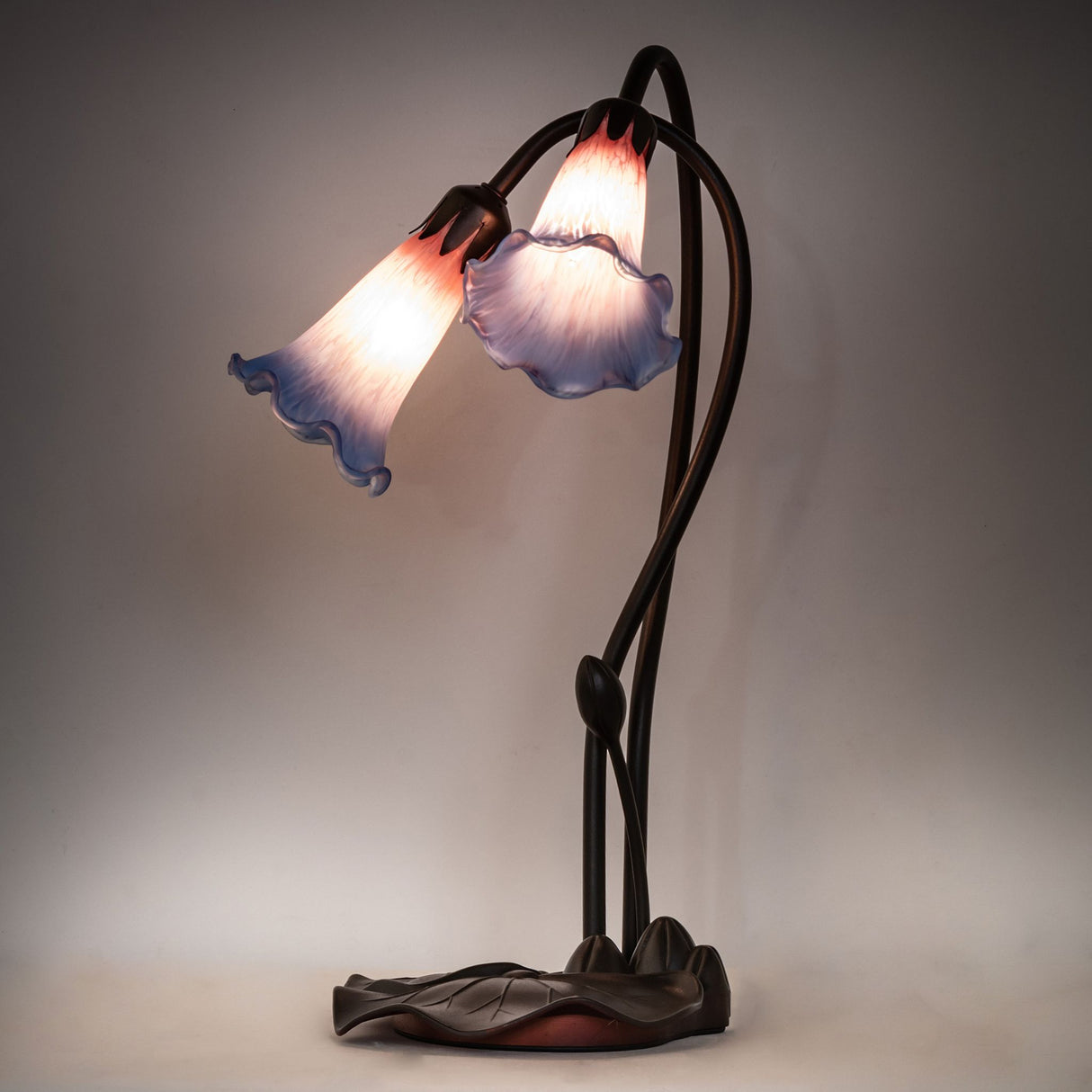 Lamp lit up showing soft pink and blue glow.