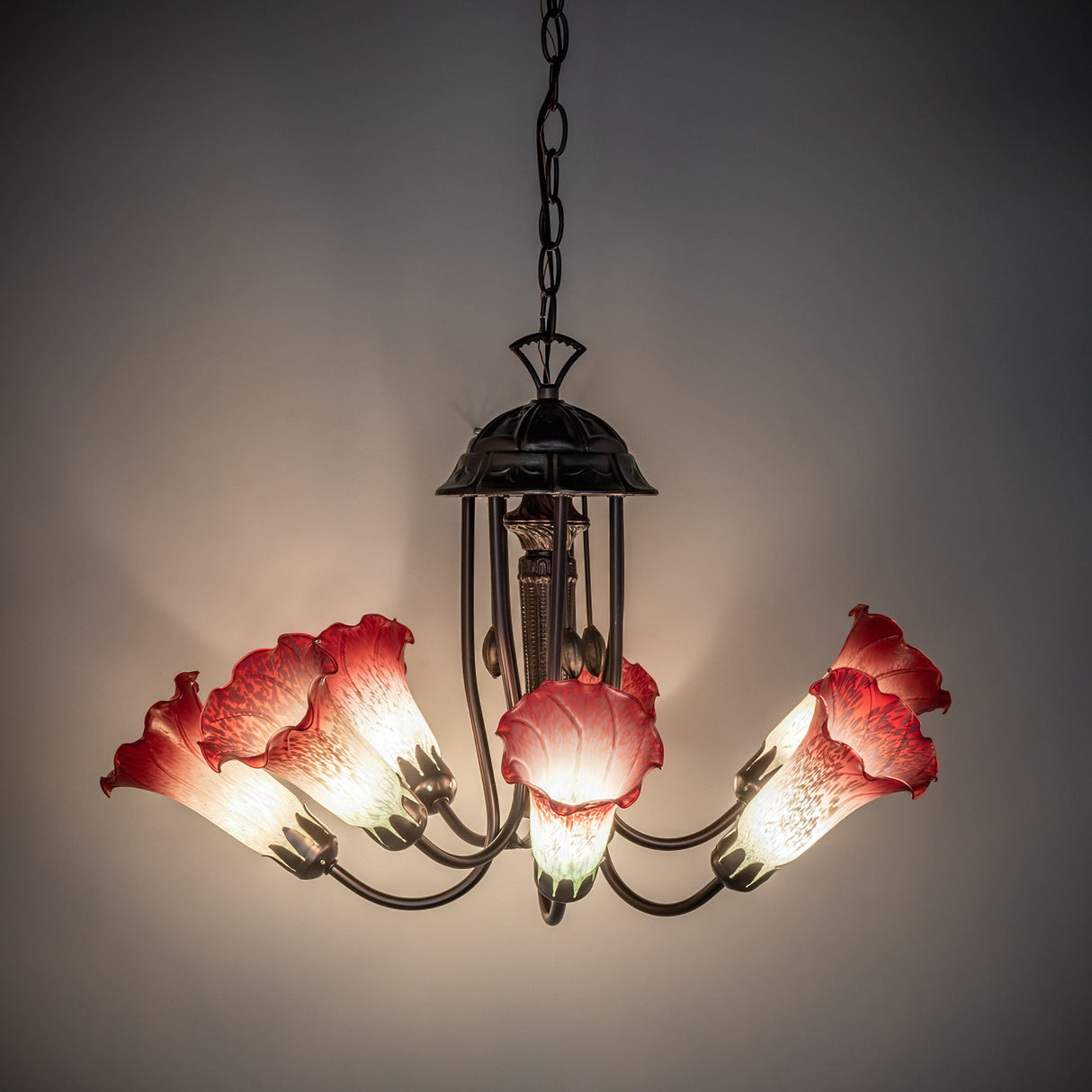 Room setting with the Tiffany pond lily chandelier illuminated, showcasing its soft lighting effect.