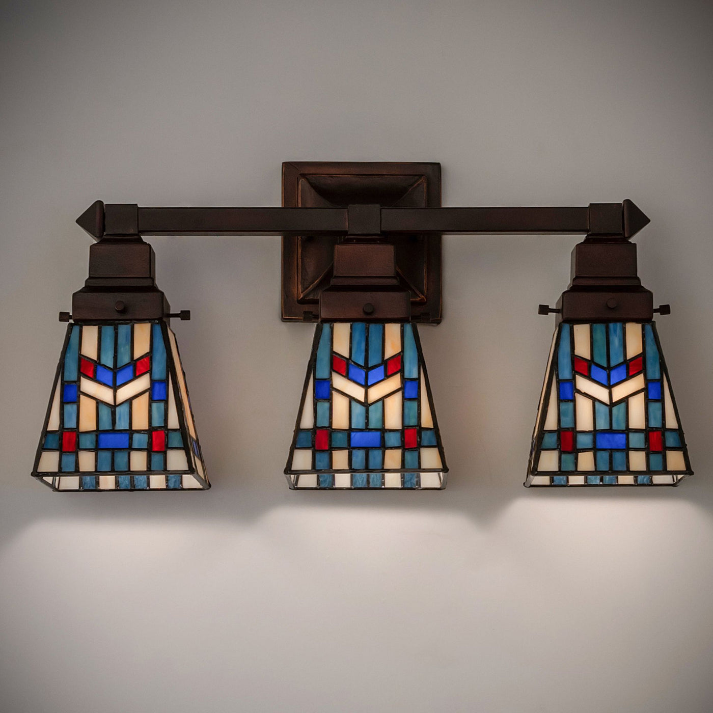 Illuminated Prairie Wheat 3 Light Vanity mounted on wall.