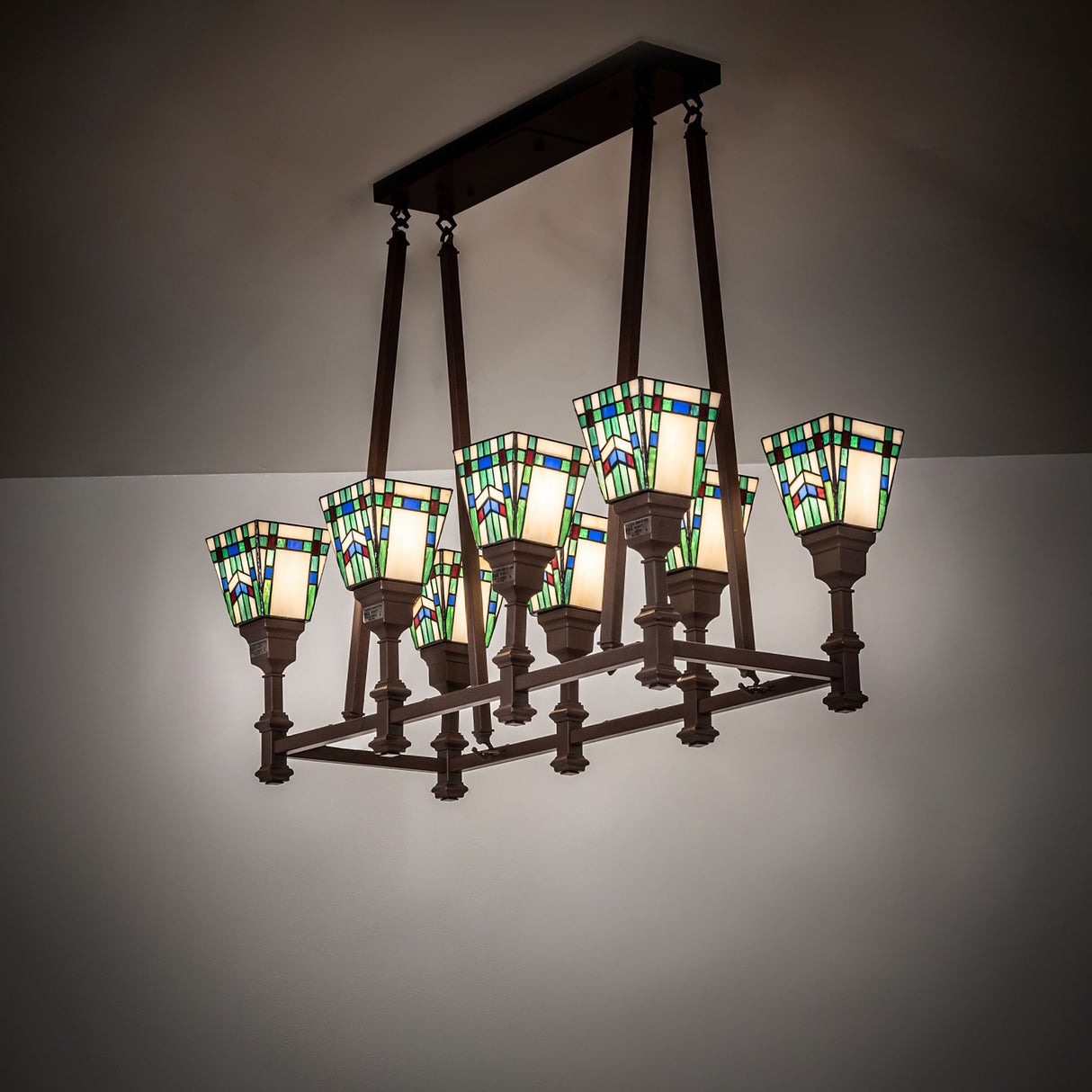 Prairie Wheat oblong chandelier shown illuminated in ambient room setting.