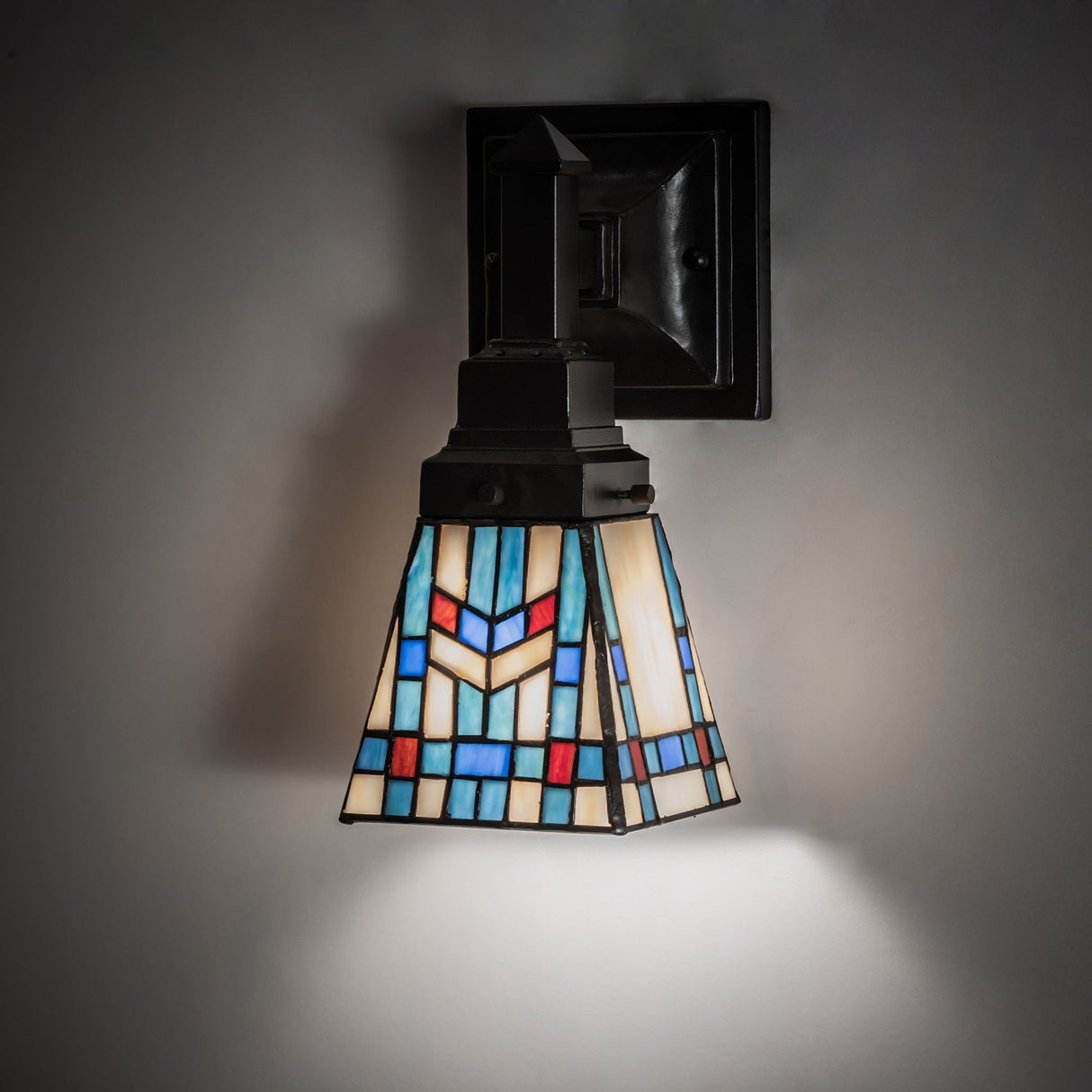 Illuminated Prairie Wheat wall sconce casting a warm glow on the wall.