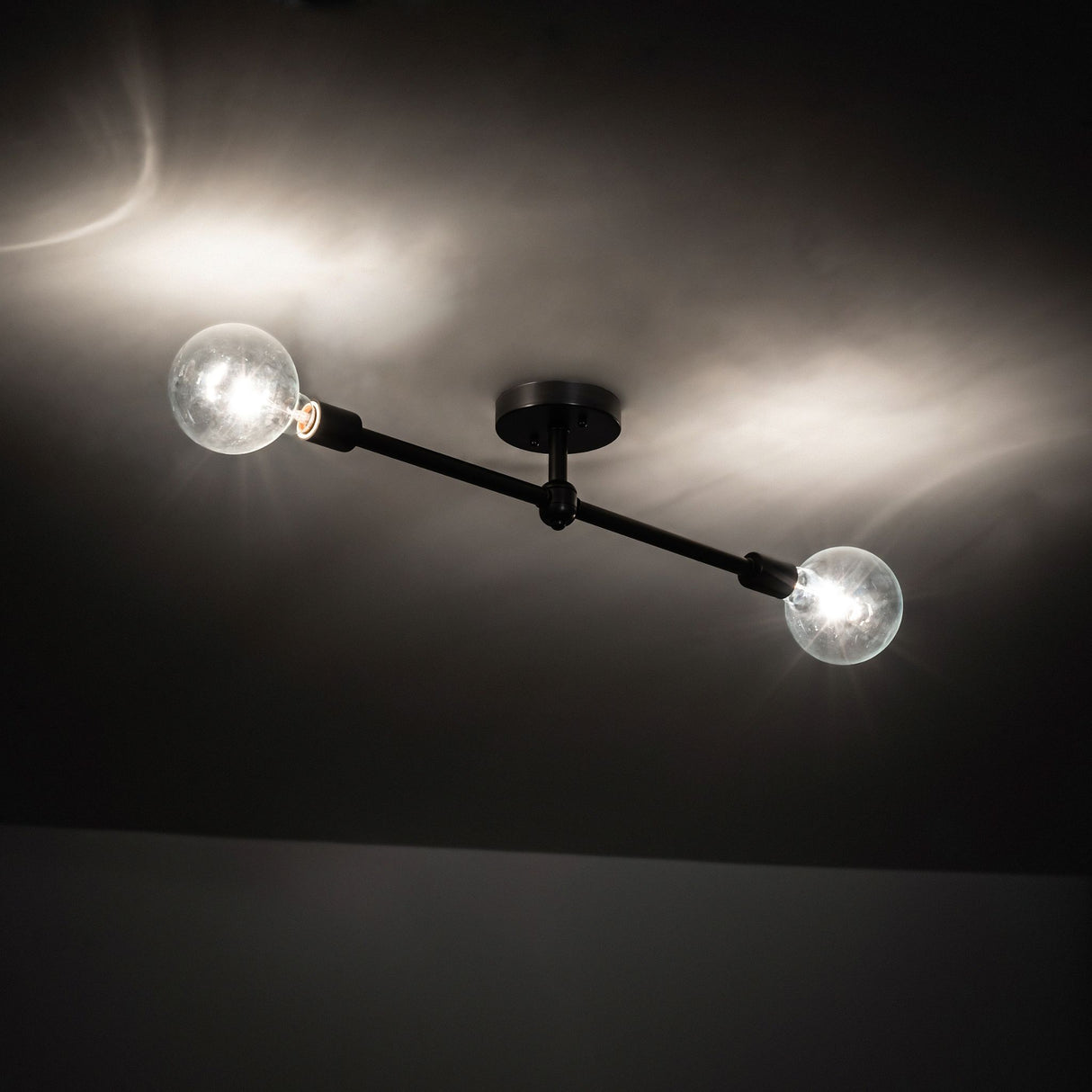 Ambient view of the Pronograde Jack 2 Light Flushmount, casting soft illumination on the ceiling.
