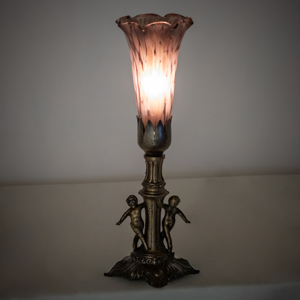 Ambient view of Pond Lily Maidens Mini Lamp, highlighting the glowing effect of its art glass shade.