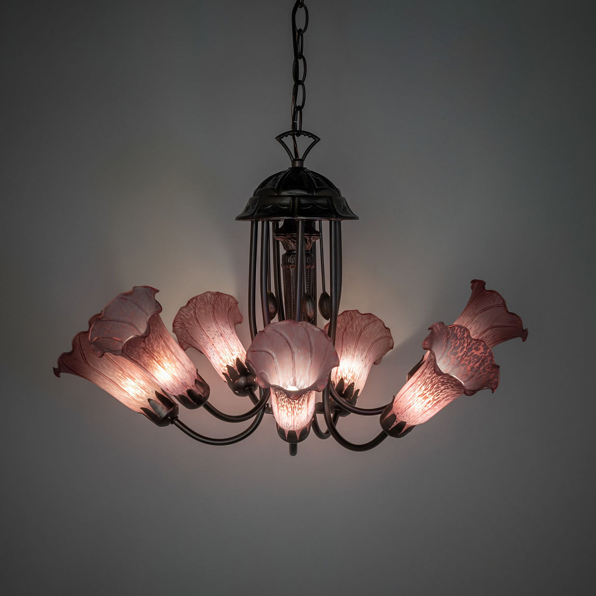 Illuminated view of Purple Tiffany Pond Lily Chandelier with glowing purple glass shades.