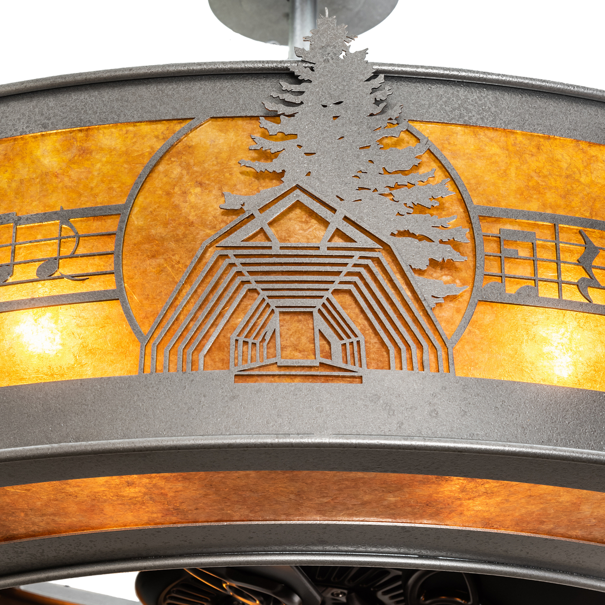 Close-up of handcrafted tree and pavilion motif with amber mica glow.