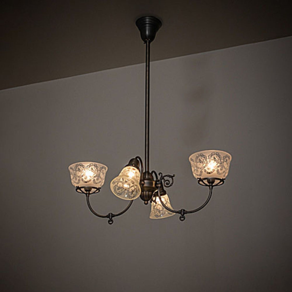 Revival gas and electric chandelier shown installed, casting warm ambient light in interior space.