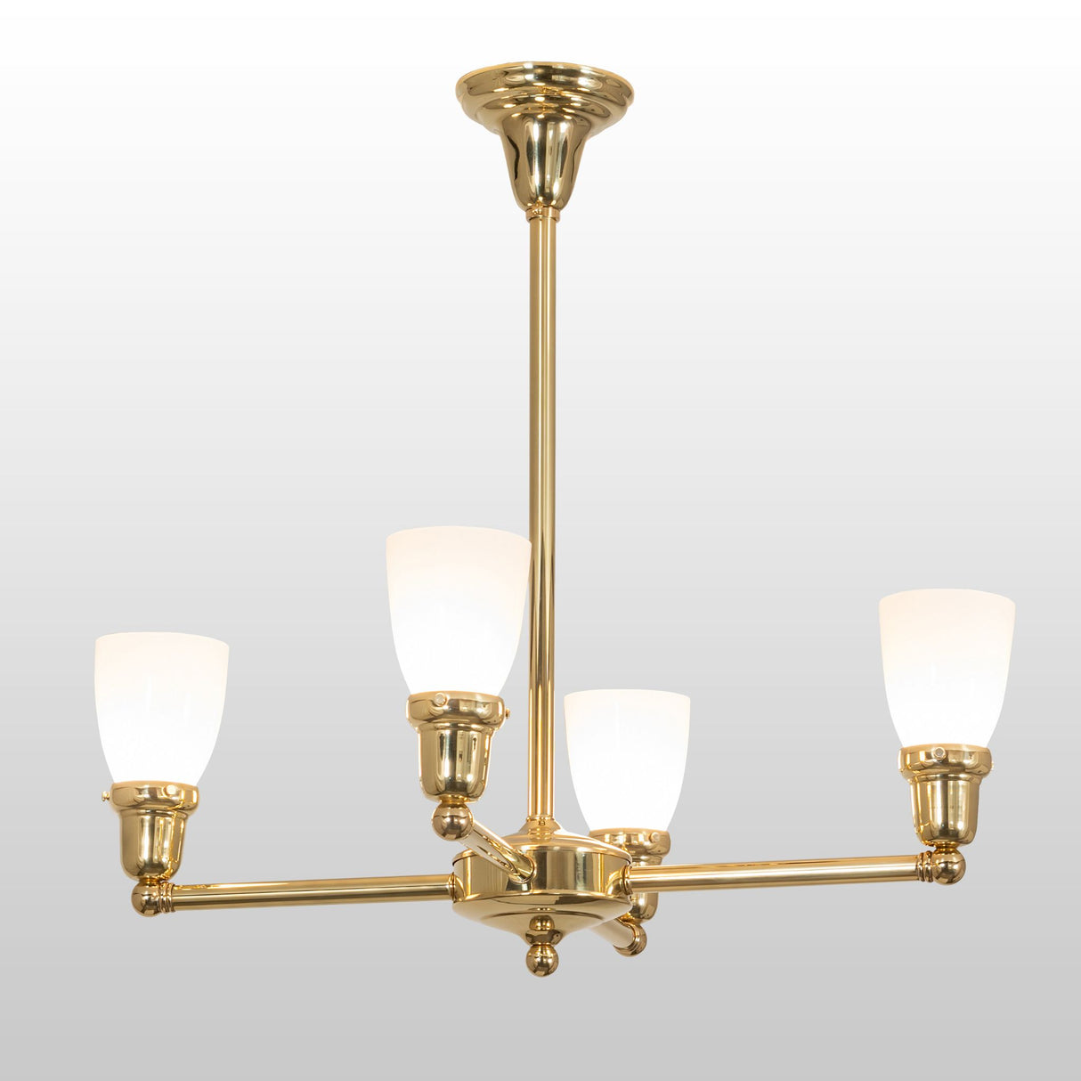 Polished brass Revival Oyster Bay Goblet chandelier with four glass shades.