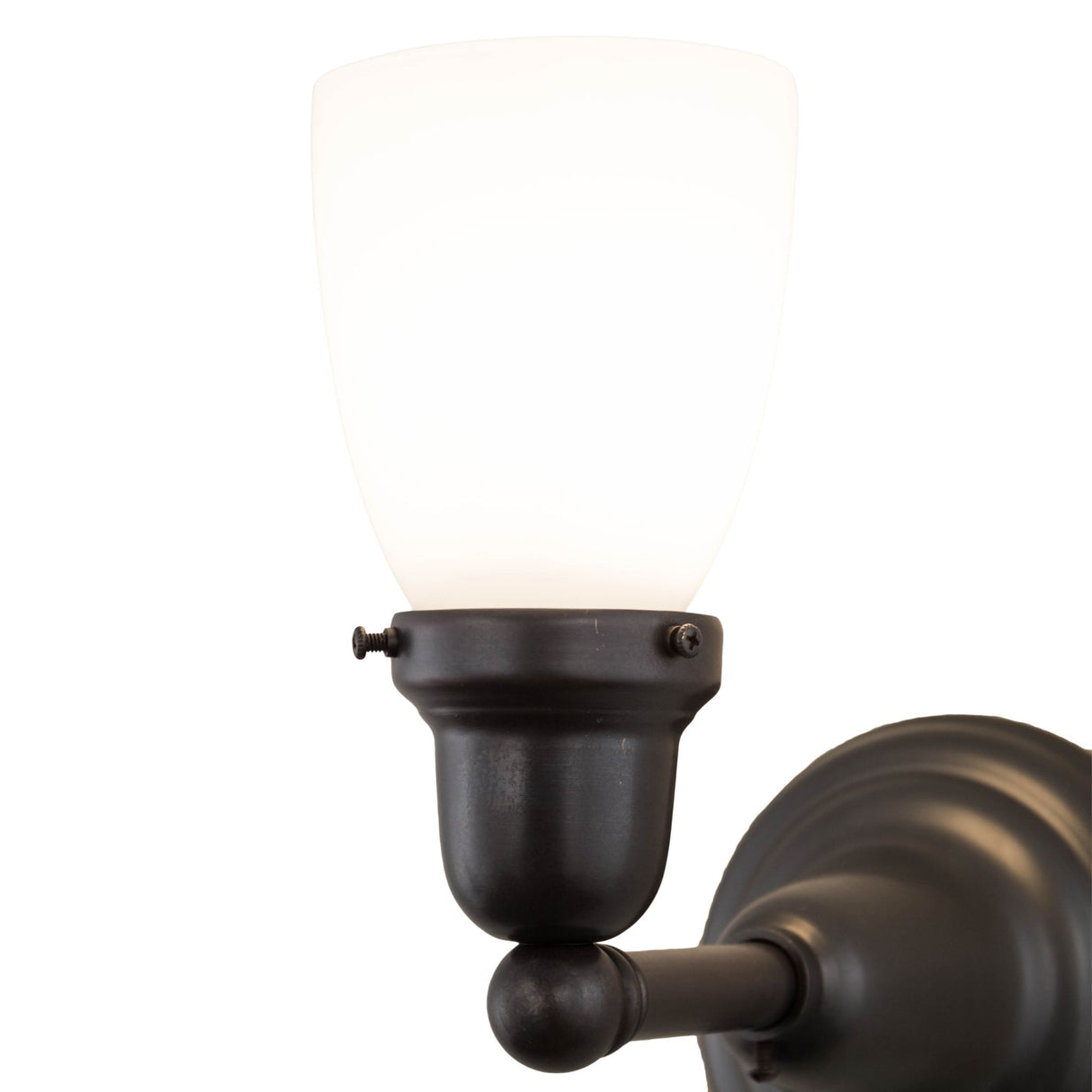 Close-up view focusing on the smooth glass shade and antique-style brass hardware.