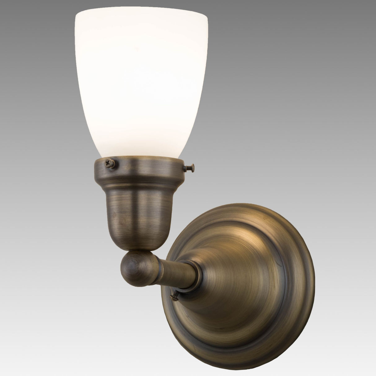 Illuminated Revival Oyster Wall Sconce with Antique White glass and Antique Brass finish.