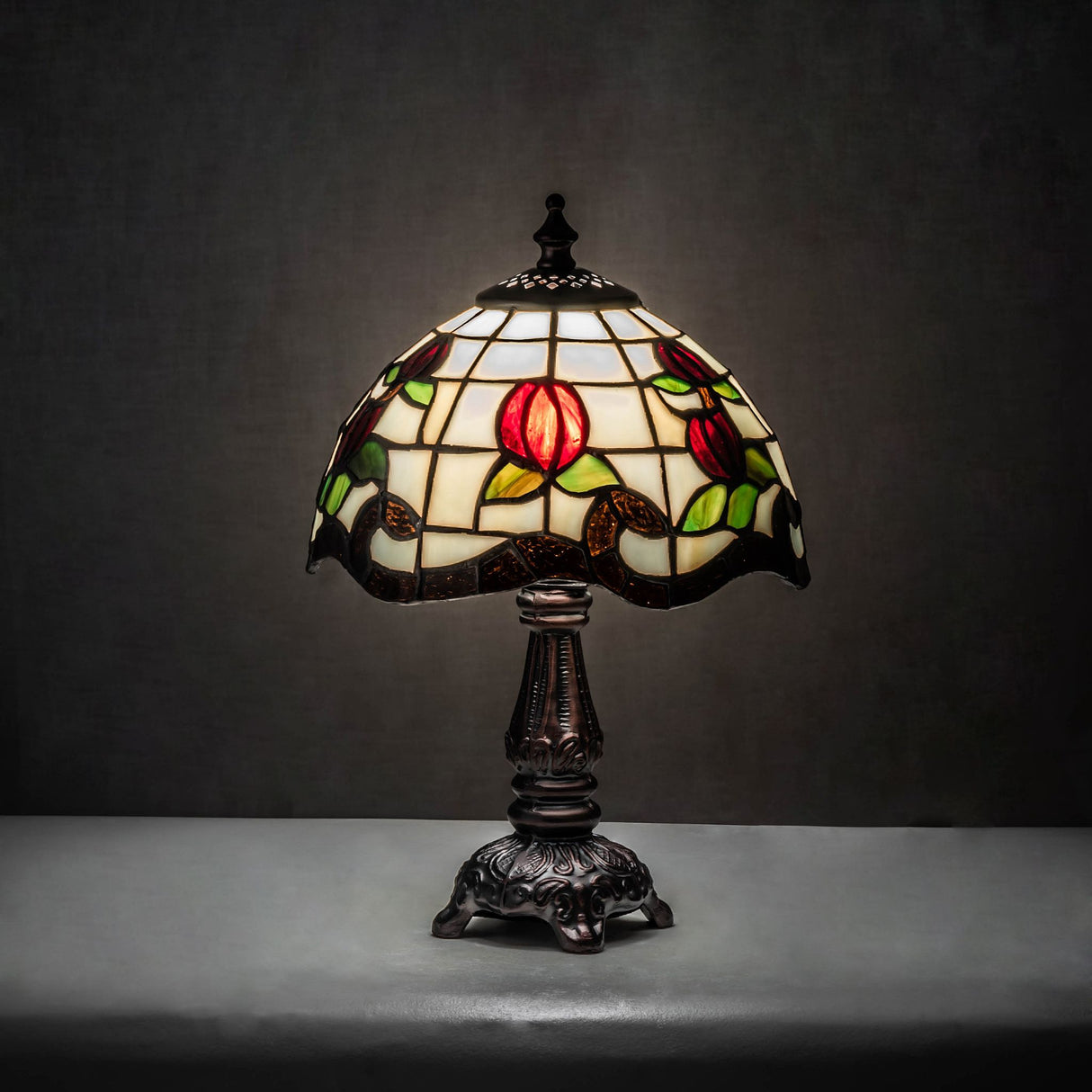 Roseborder mini lamp illuminated in a dim setting with vibrant rose details.