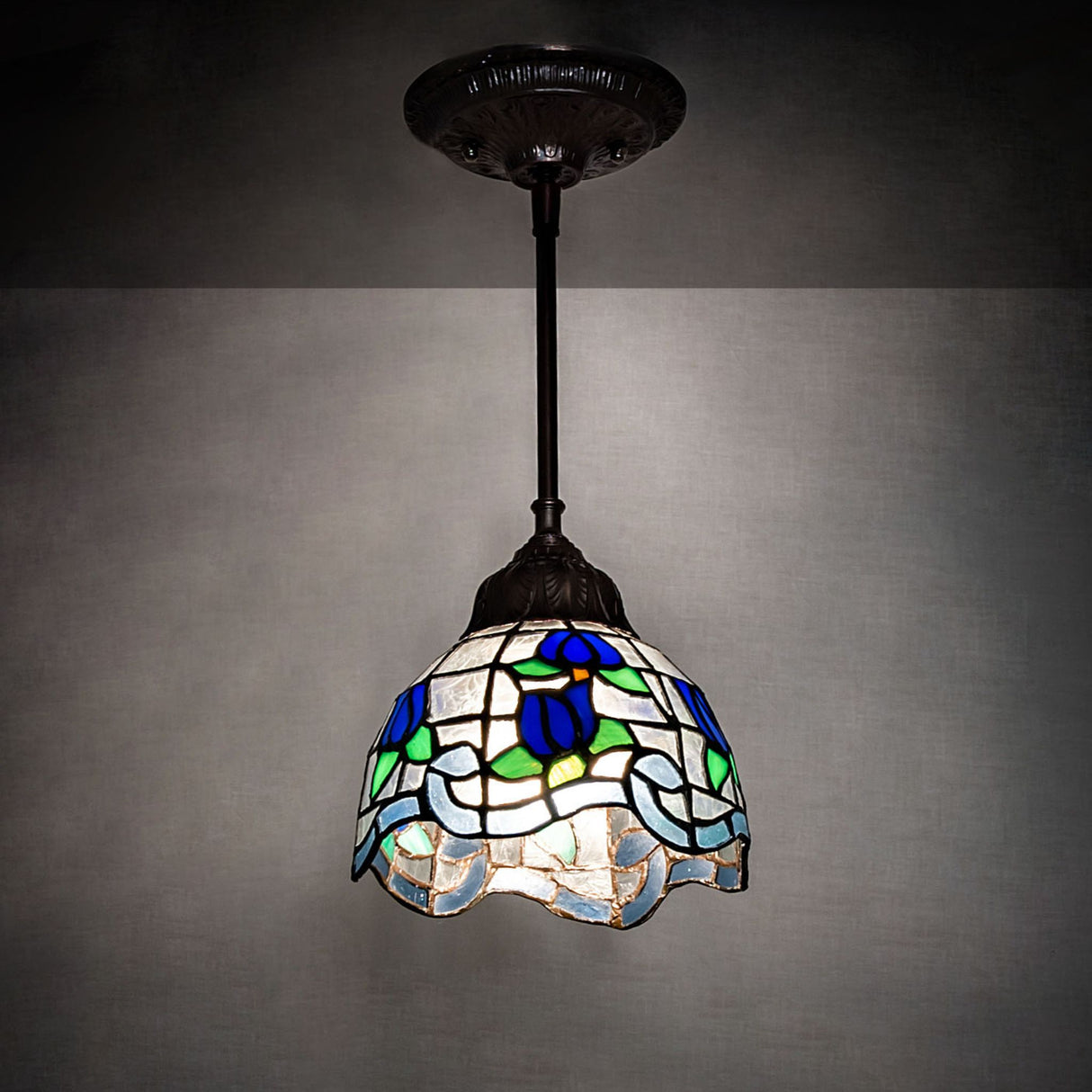 Roseborder Mini Pendant in a lit room with vivid colors.