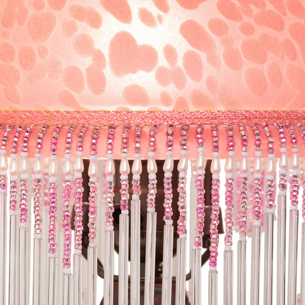 Close-up of the Roussillon Cherub Mini Lamp, focusing on the detailed glass beaded fringe and metal trim.