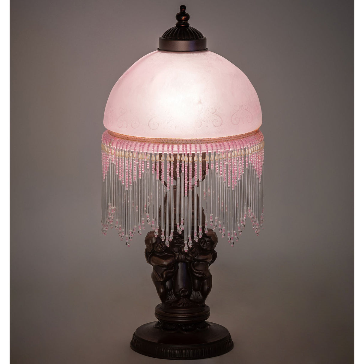 Illuminated view of the Roussillon Cherub Mini Lamp showcasing soft ambient lighting.