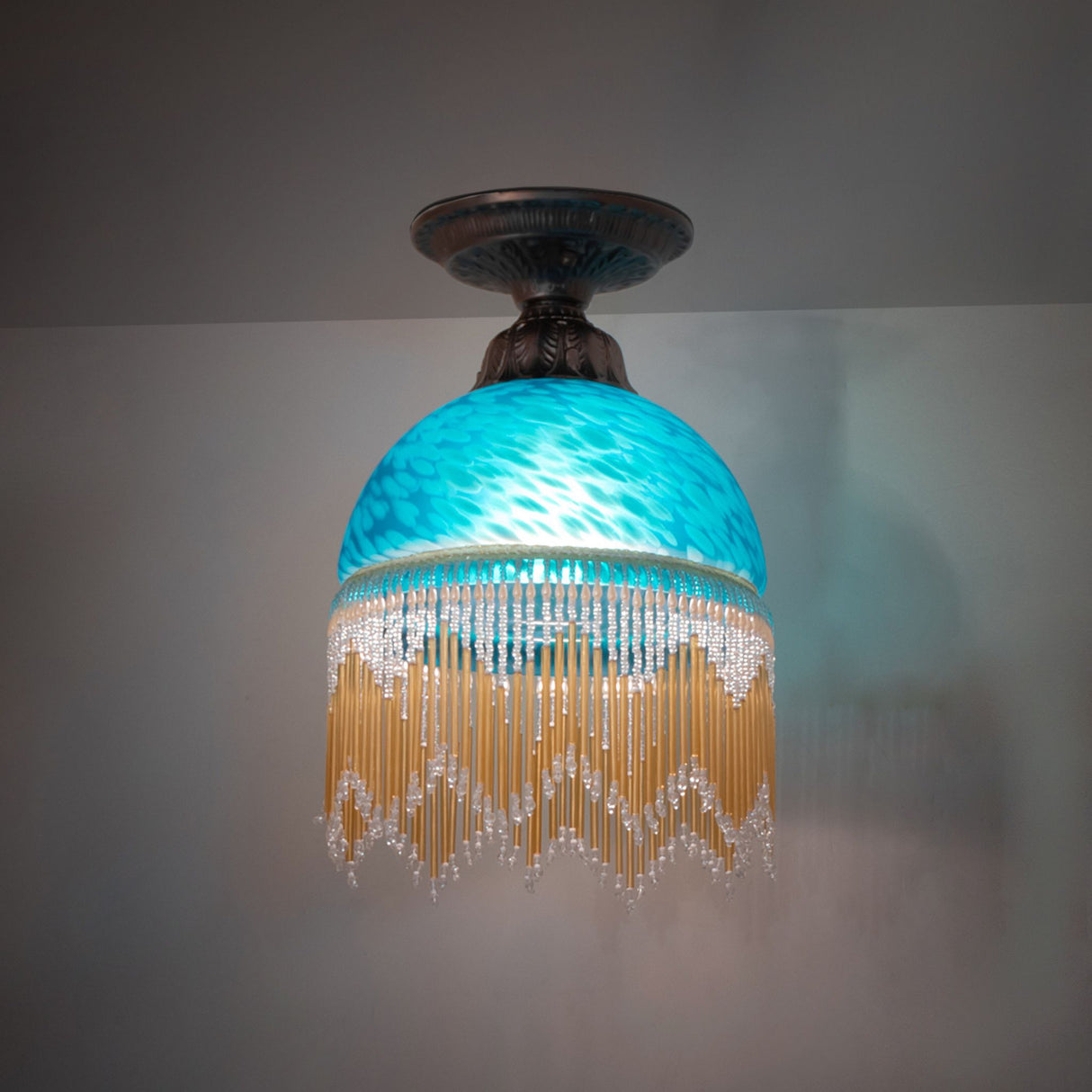 illuminated dark view of roussillon flushmount with elegant Victorian accents.