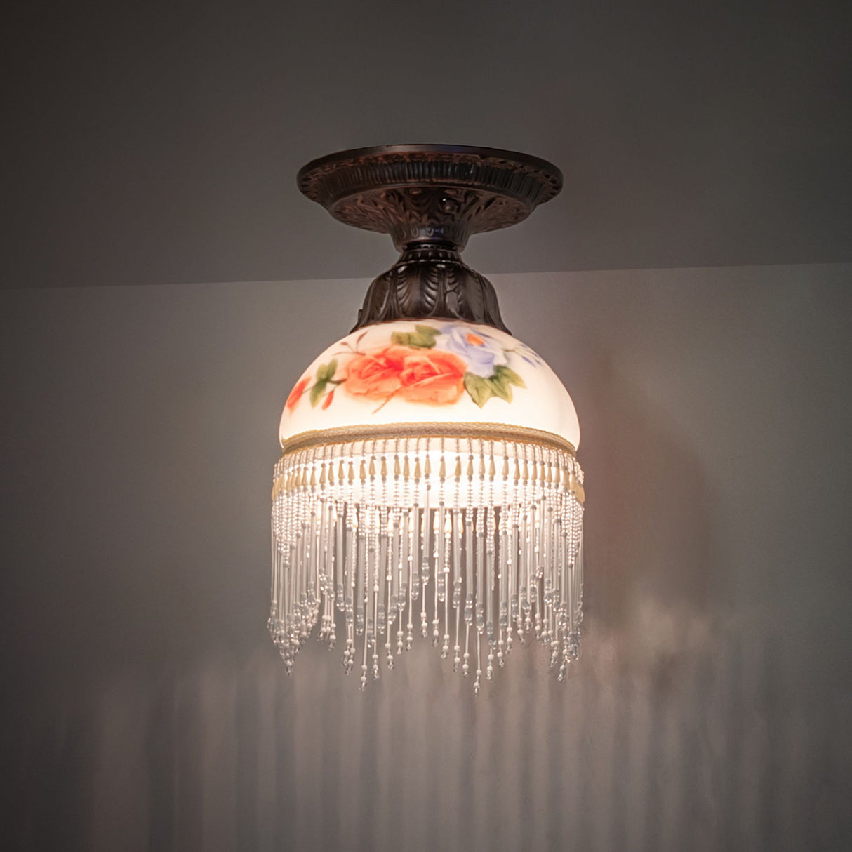 illuminated dark view of roussillon rose bouquet flushmount with elegant floral accents.