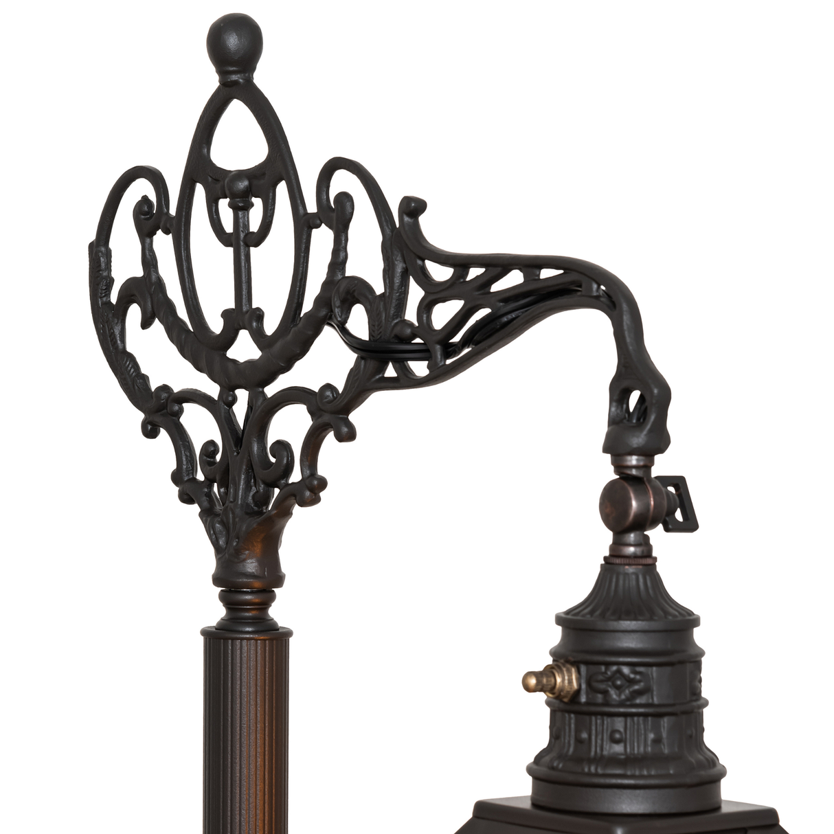 Close-up of ornate wrought iron lamp arm and hardware.