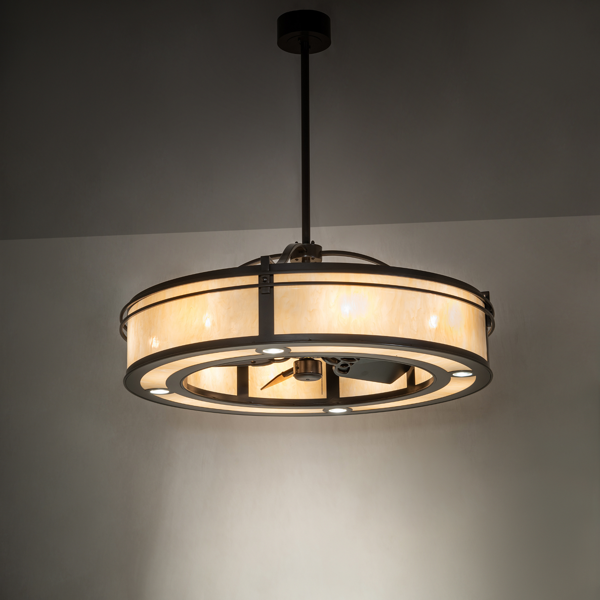 Illuminated chandelier fan glowing softly in a warm ambient room setting.