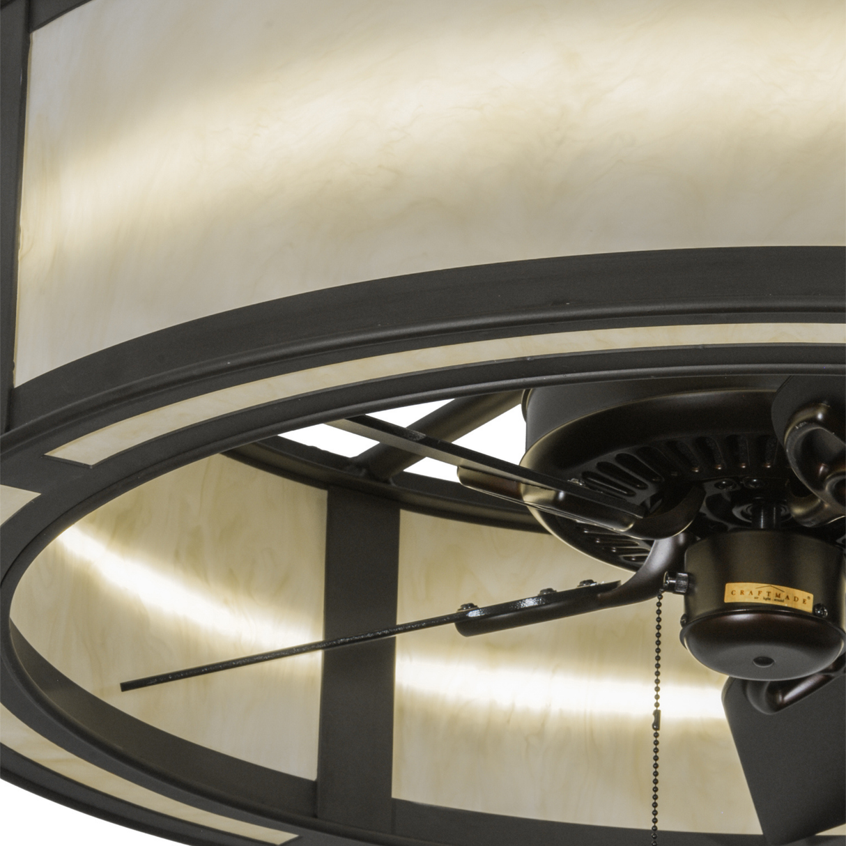 Closeup showing fan blades and smooth bronze detailing beneath shade.