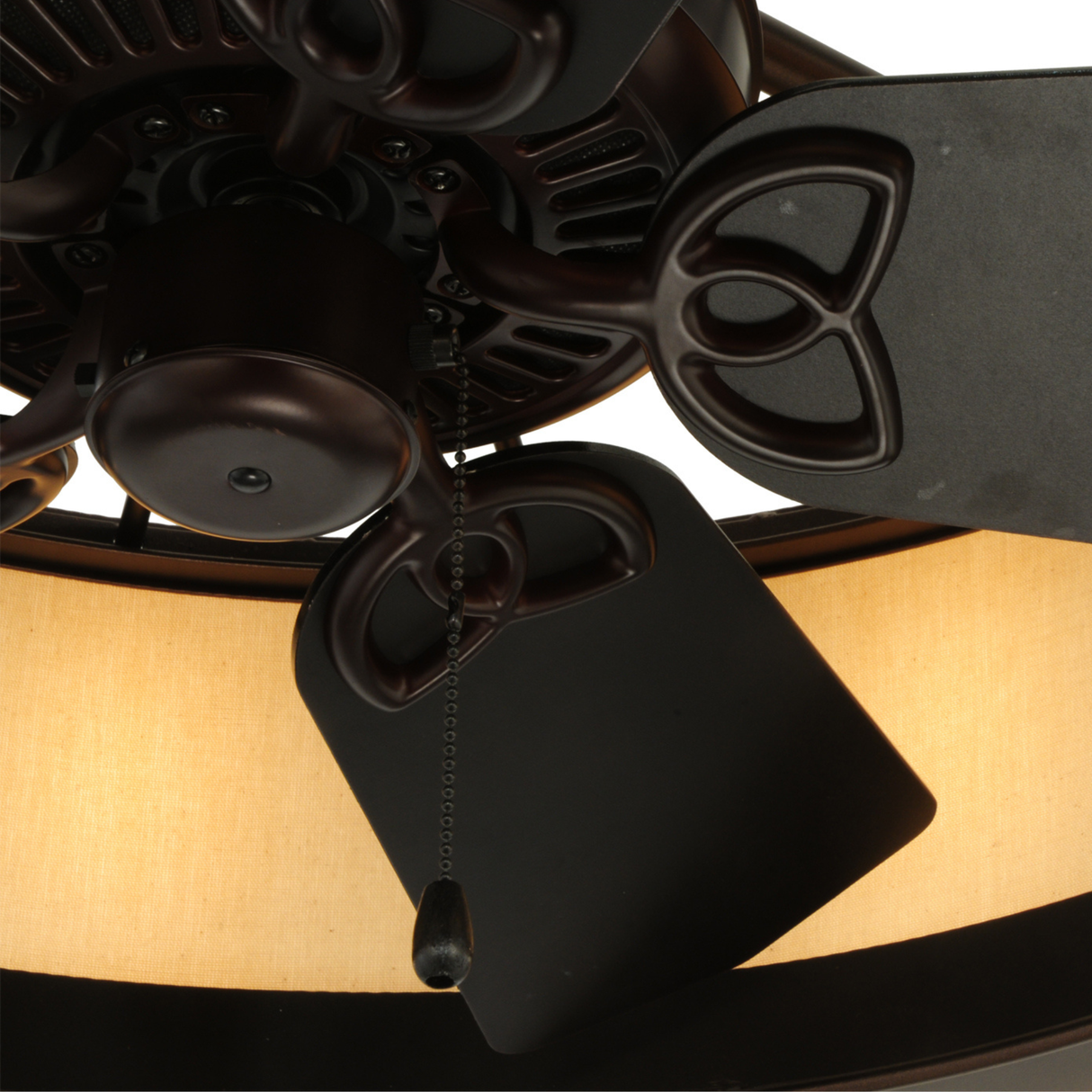 Close-up of fan blades and motor detail with warm light glow.