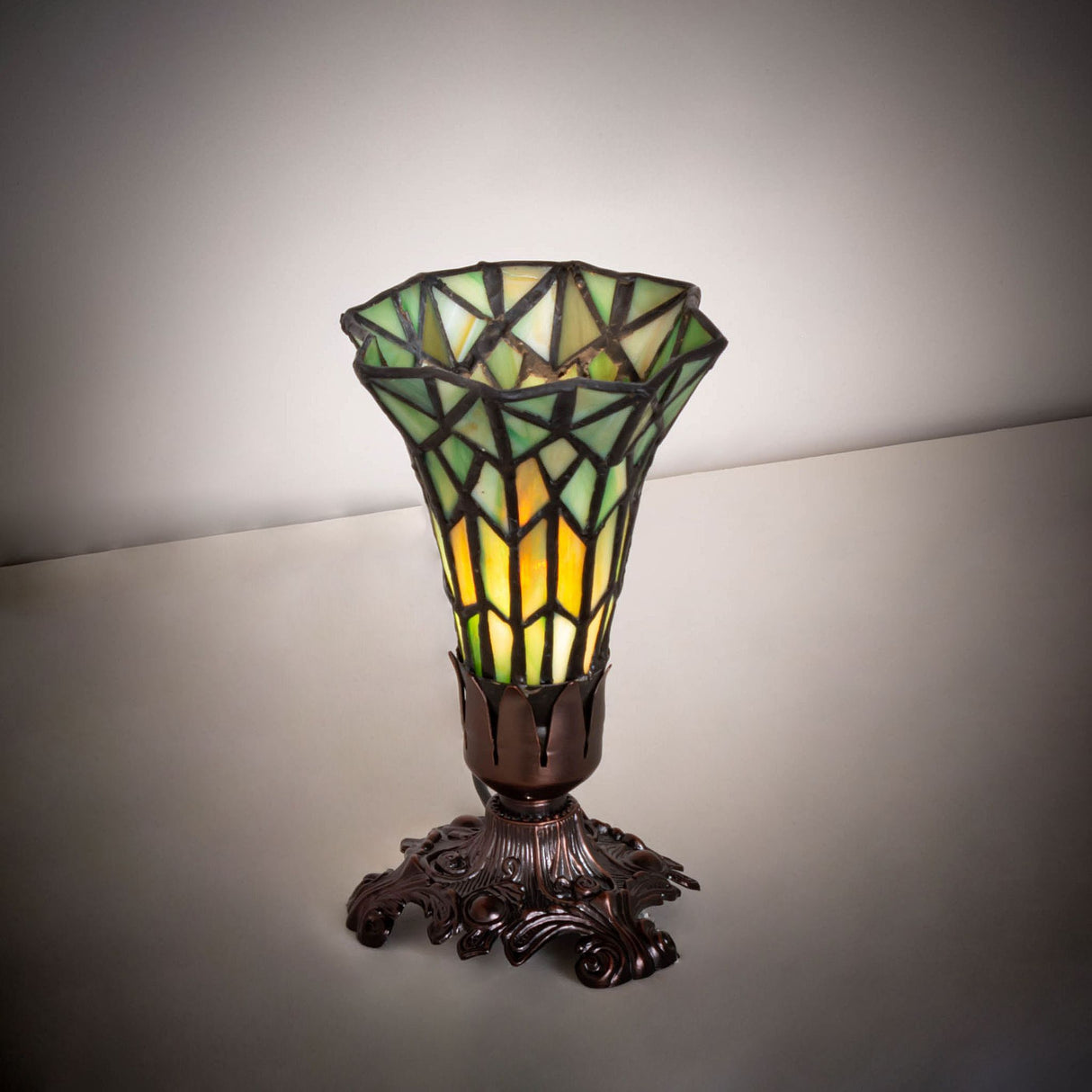 Illuminated view of the pond lily accent lamp showcasing its green and amber glow.