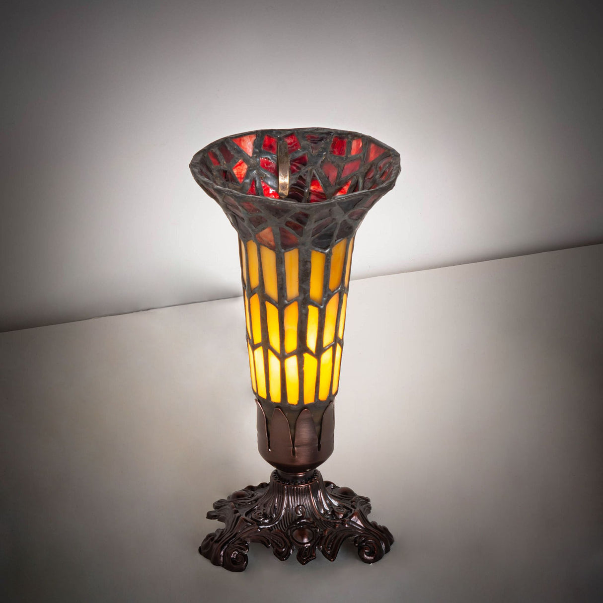 Illuminated 8" stained glass Pond Lily Victorian accent lamp showcasing vibrant amber glow.