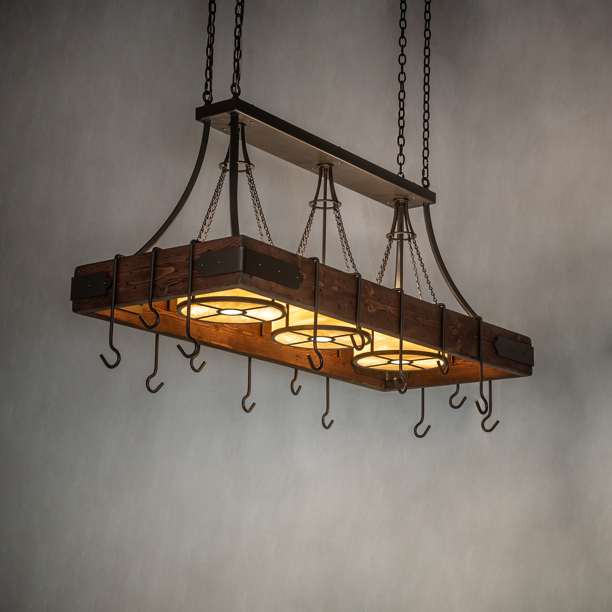Ambient lit view of Steamboat chandelier over kitchen island.