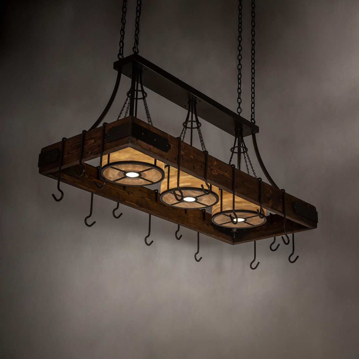 Side-lit room view of Steamboat pot rack chandelier.
