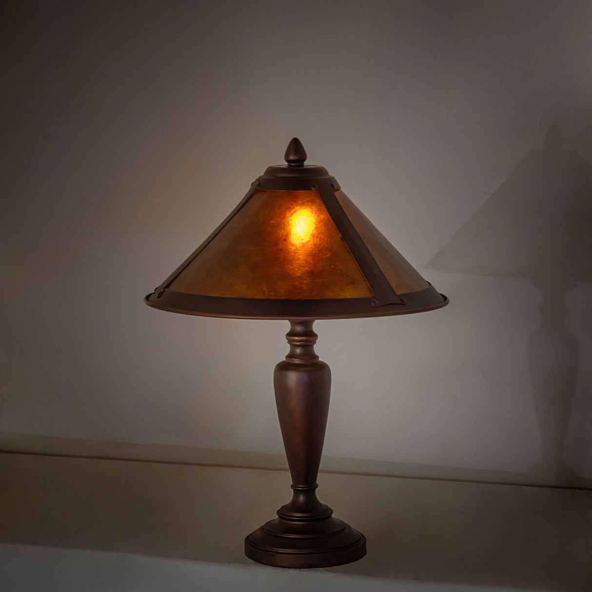 Sutter Accent Lamp illuminated on a wall shelf.