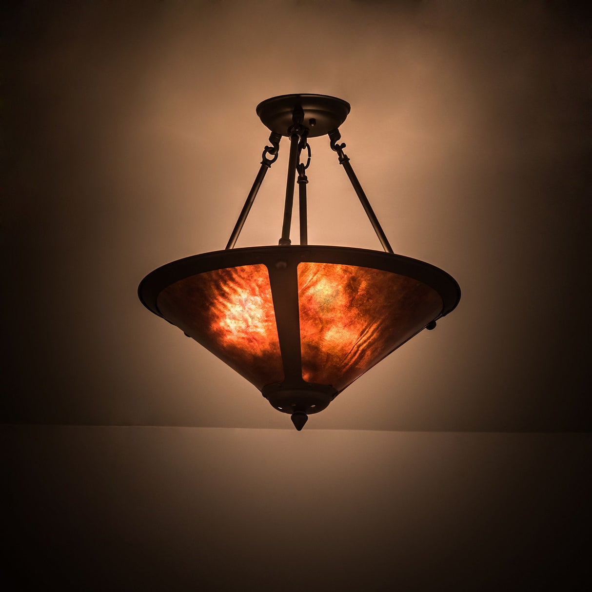 Illuminated Sutter inverted pendant creating a warm amber ambiance.