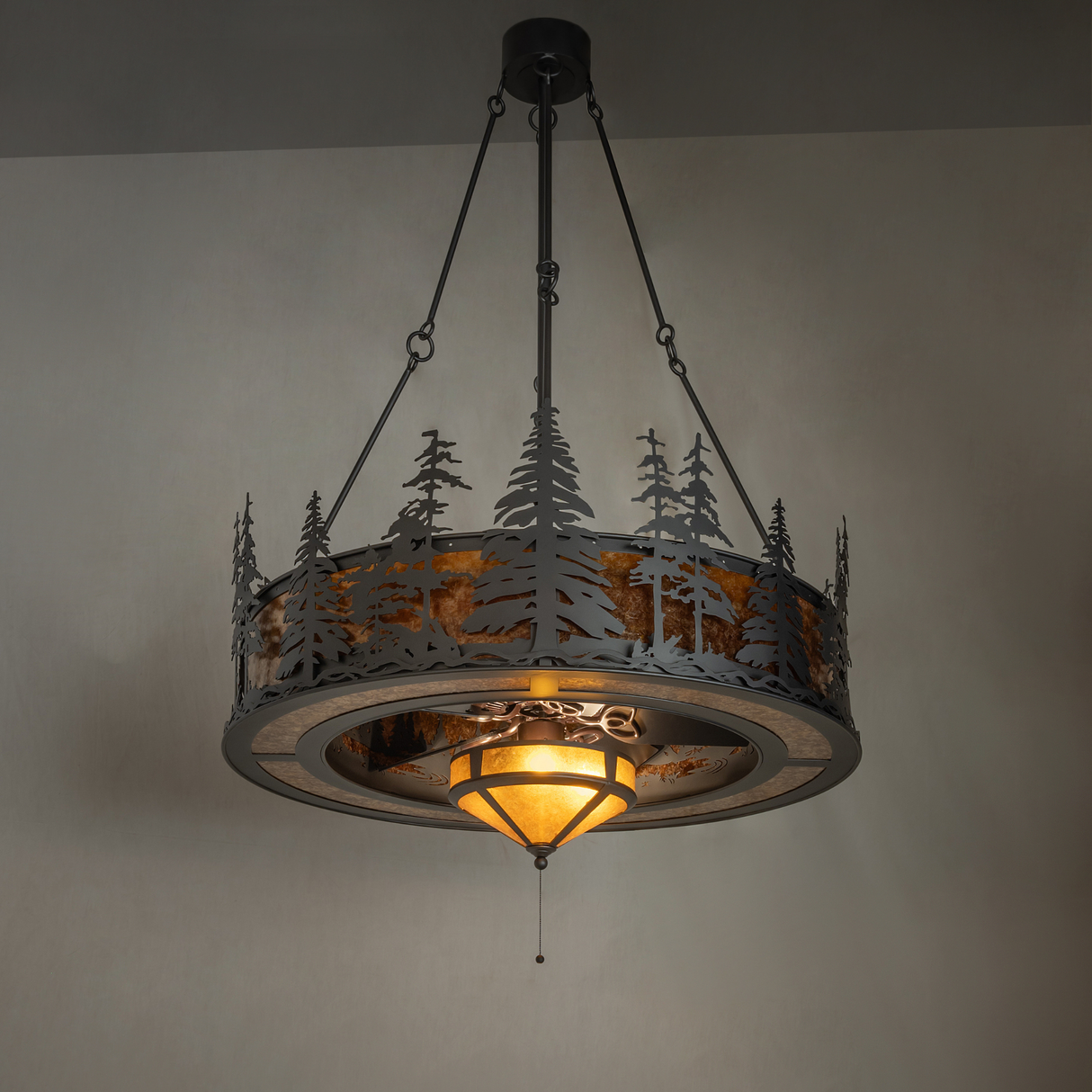 Alternate ambient view of Tall Pines chandelier fan with forest silhouette glow.