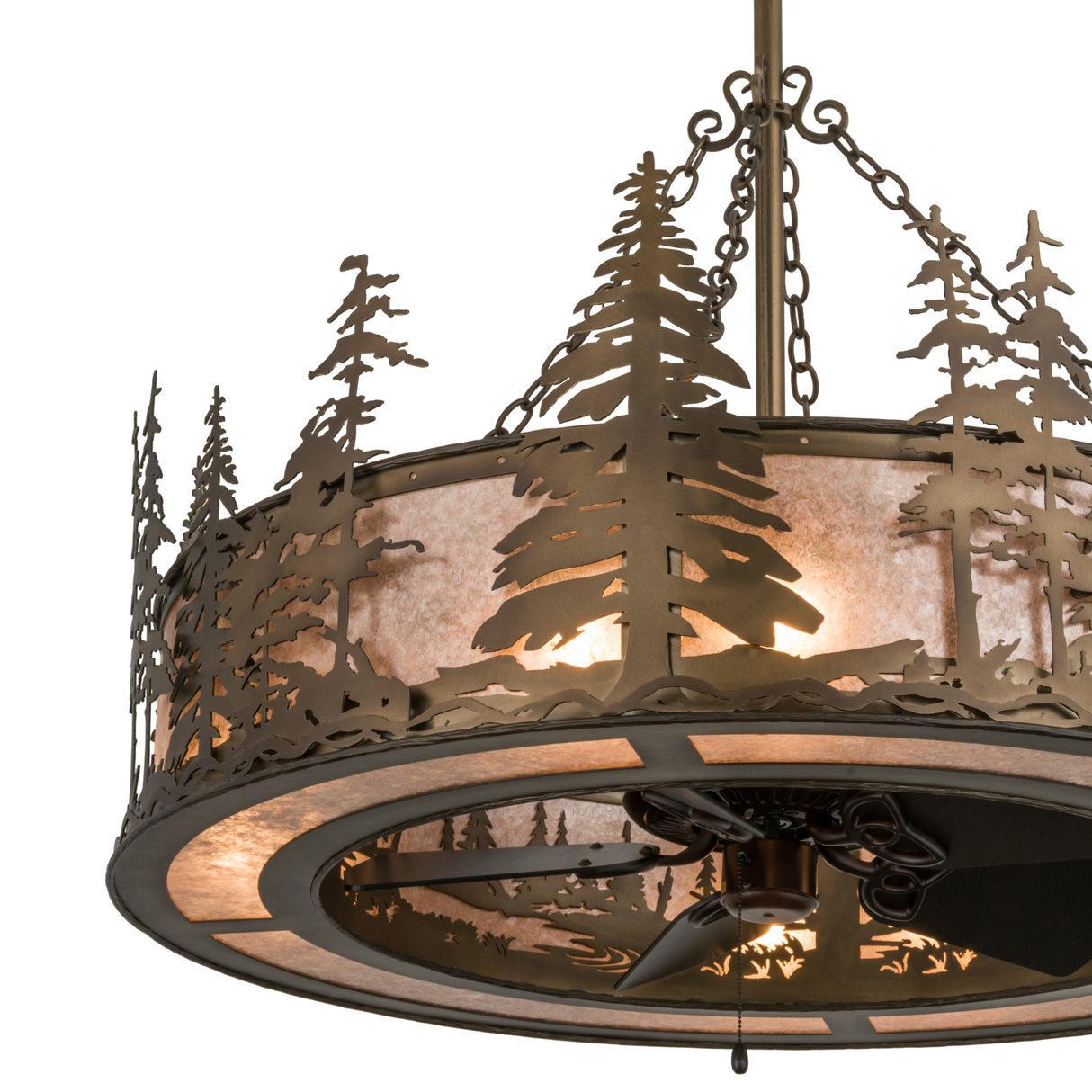 Closeup showing intricate pine tree metalwork and glowing mica shade.