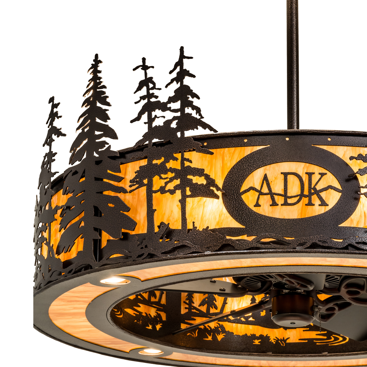Close-up lit view of ADK logo and intricate pine tree silhouette details.
