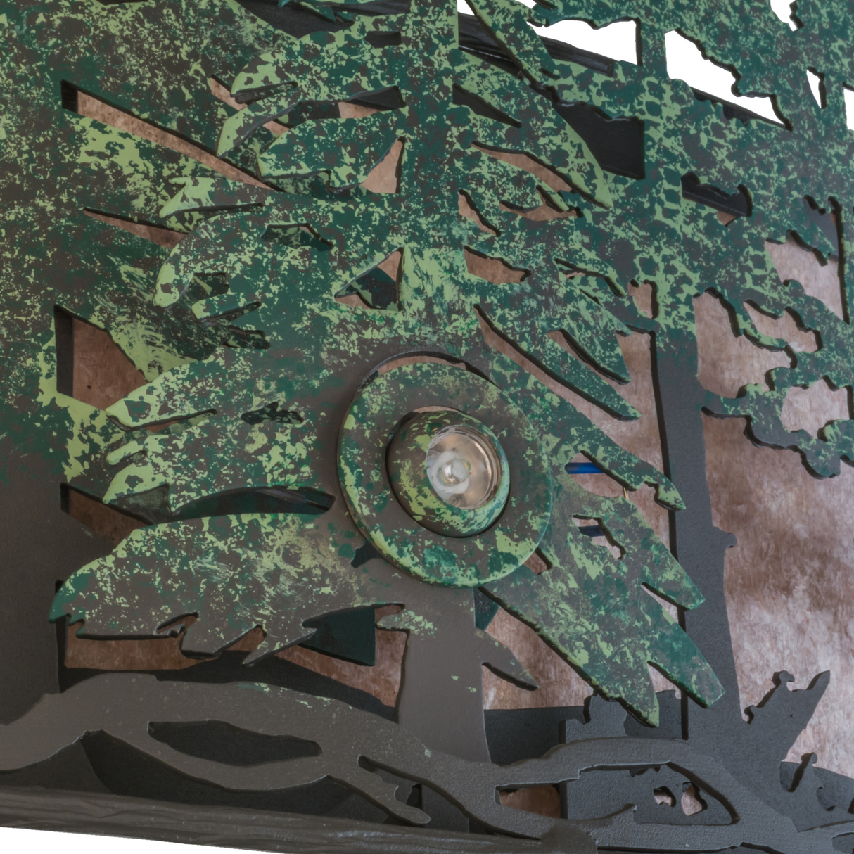 Detailed view of pine tree cutouts with rustic hand-finished texture.
