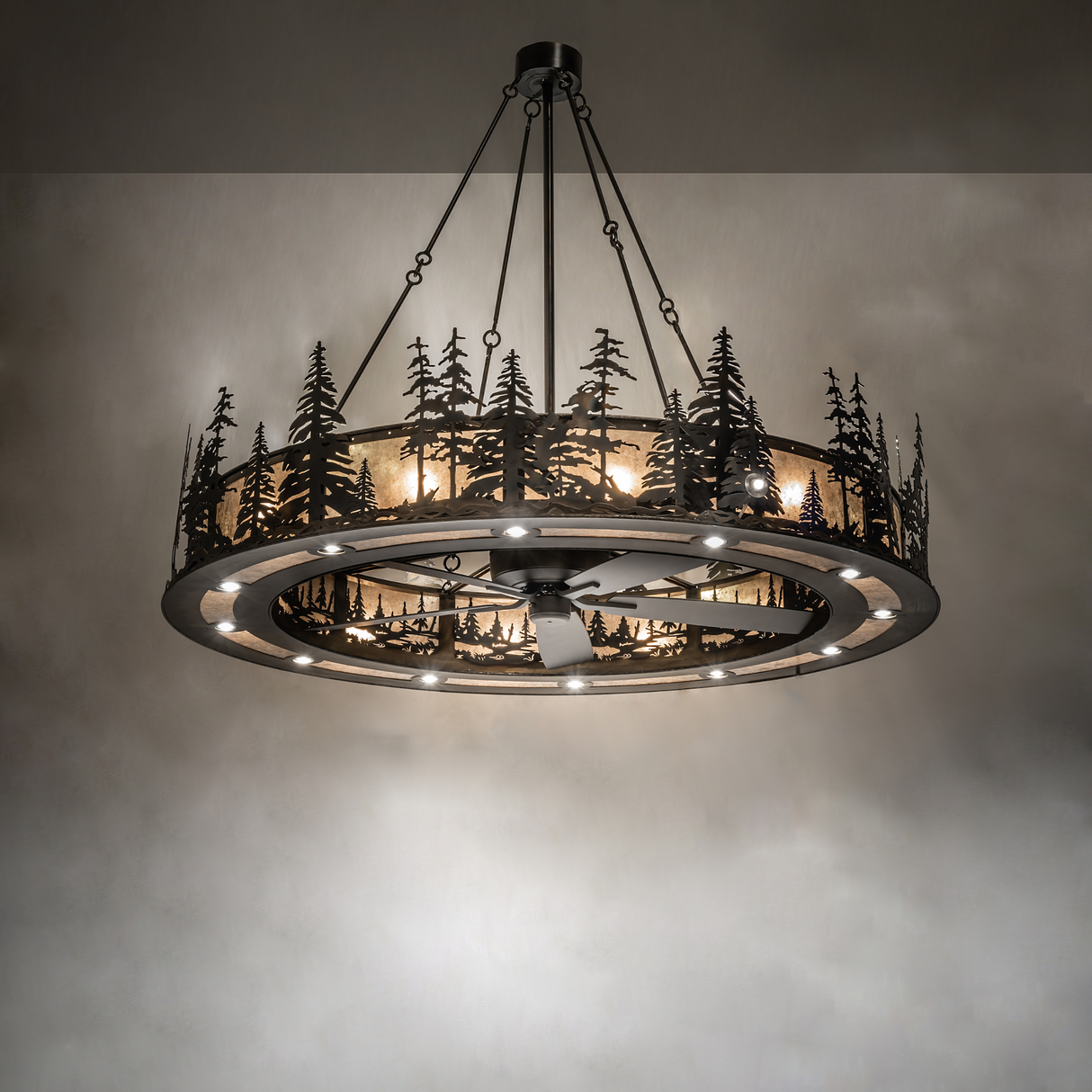 Illuminated chandelier fan casting warm forest-themed glow.
