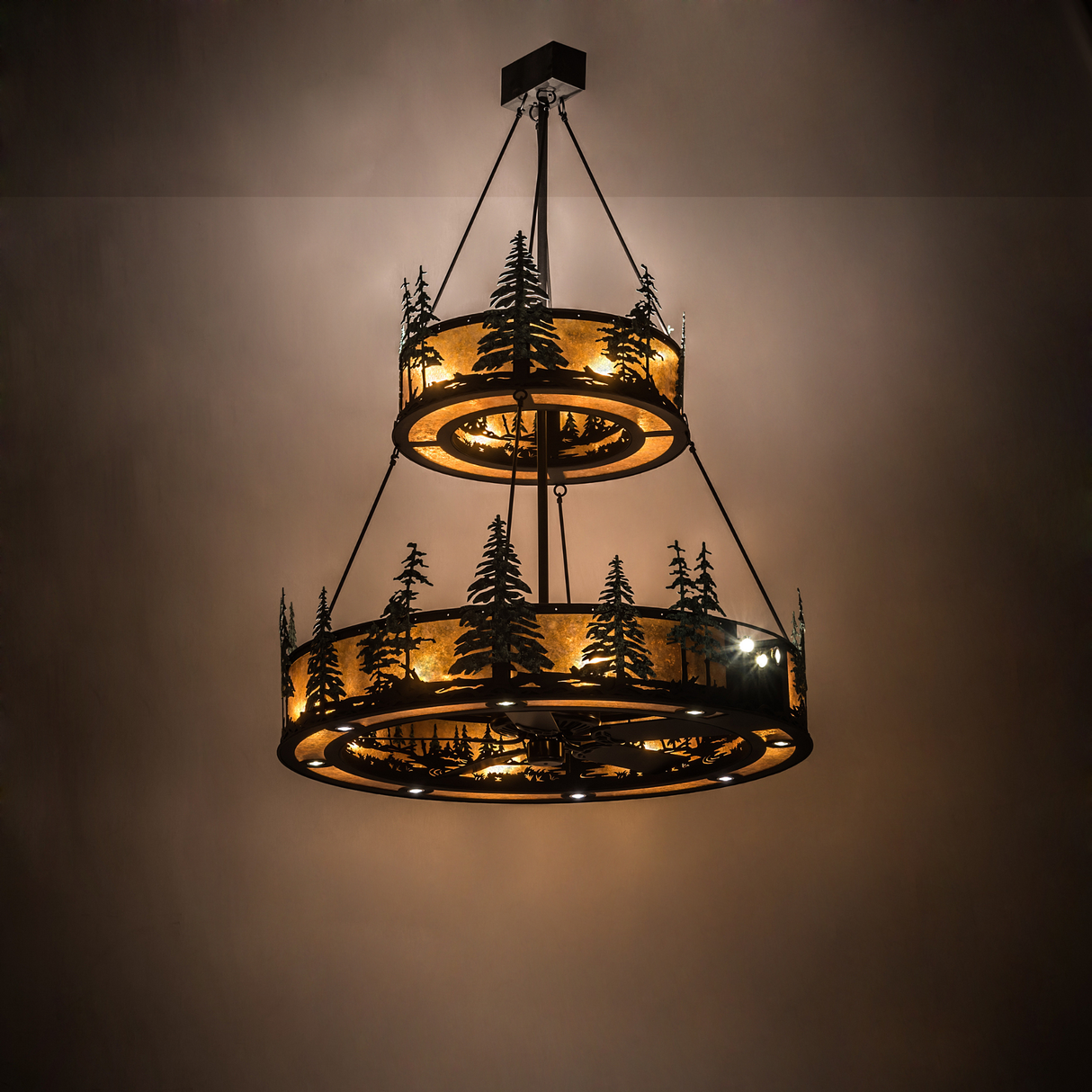 Illuminated Tall Pines Chandel-Air glowing warmly in a rustic room setting.