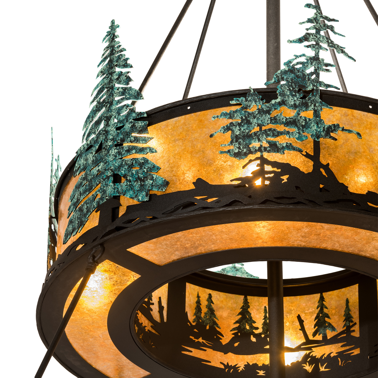 Close-up of illuminated upper tier with hand-painted pine tree silhouettes and amber mica diffuser.