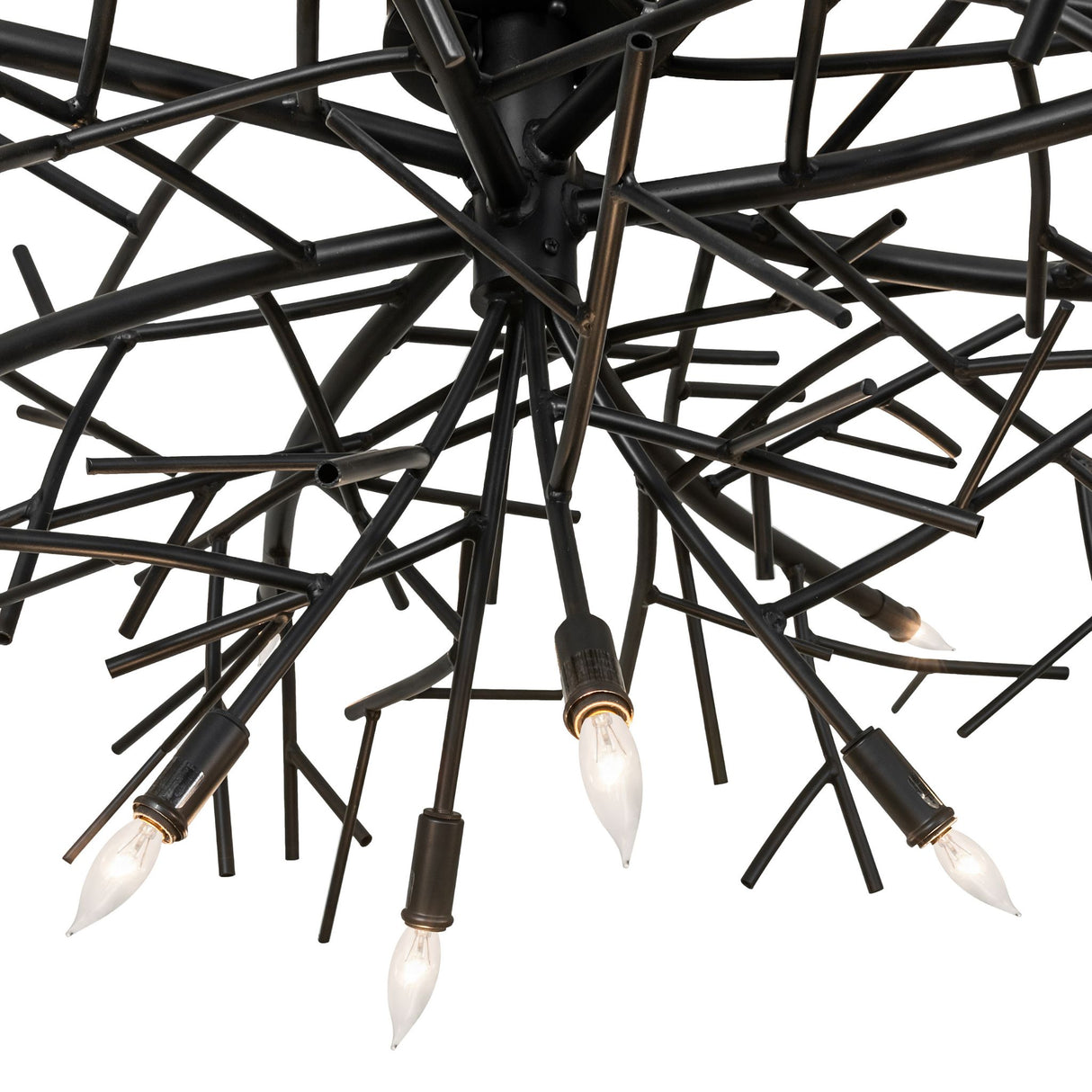 Close-up of chandelier metal branches with blackwash finish and handcrafted welded details.