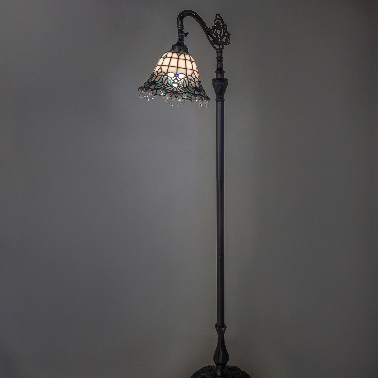 Angelica stained glass floor lamp glowing in ambient light.