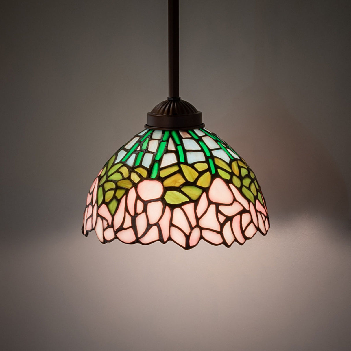 Illuminated Tiffany cabbage rose mini pendant in room setting.