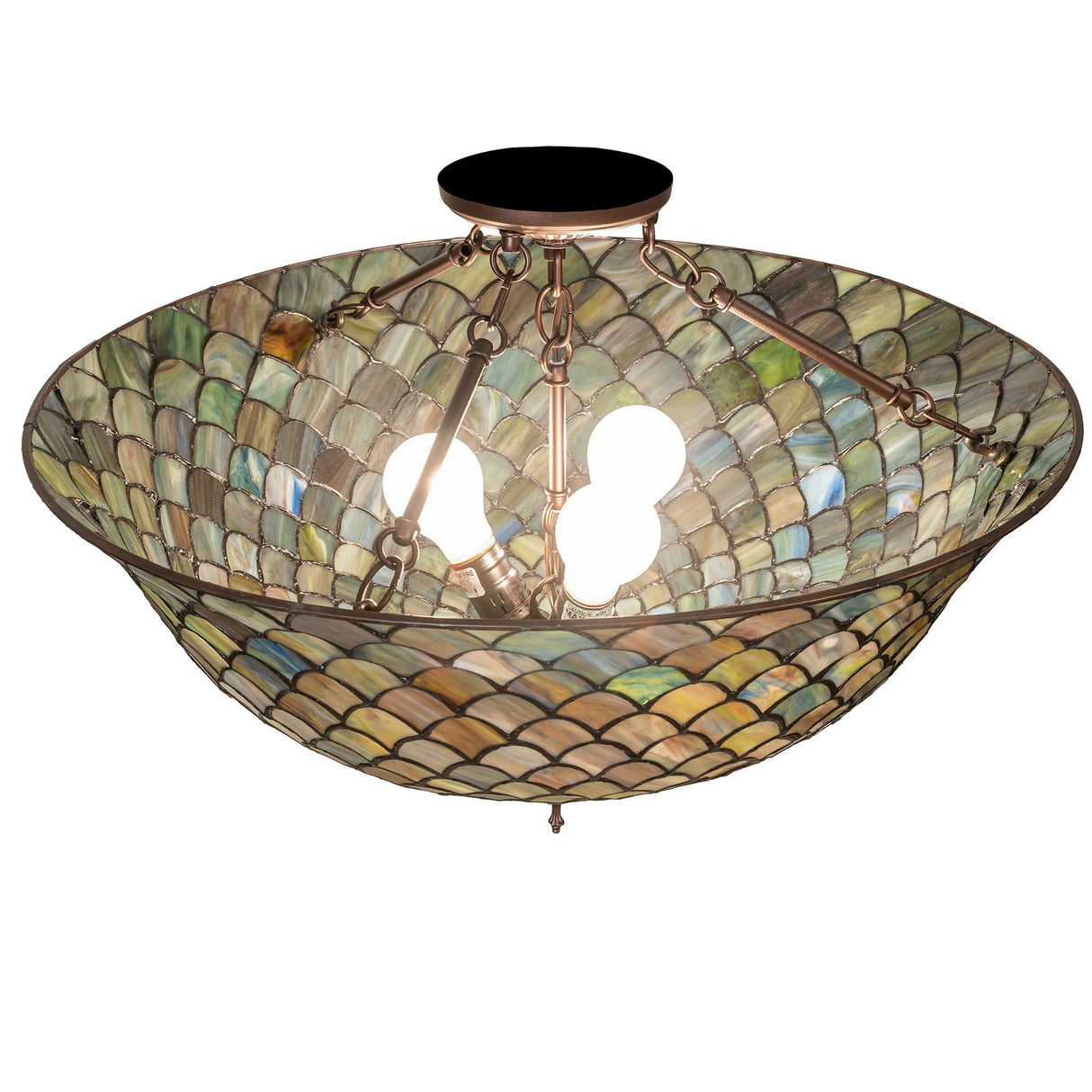tiffany fishscale flushmount illuminated with warm light.