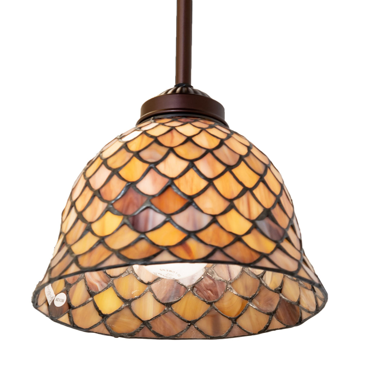 Tiffany Fishscale Pendant glowing warmly.