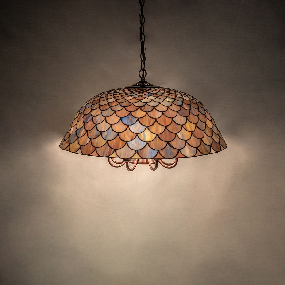 Illuminated Tiffany Fishscale Pendant displaying its brilliant hues.