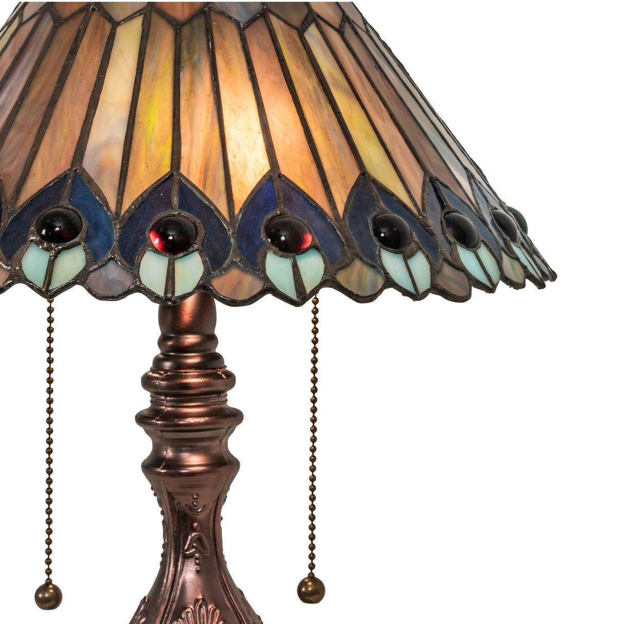 Close-up of the Tiffany Jeweled Peacock lamp’s stained glass pattern with jewel accents.