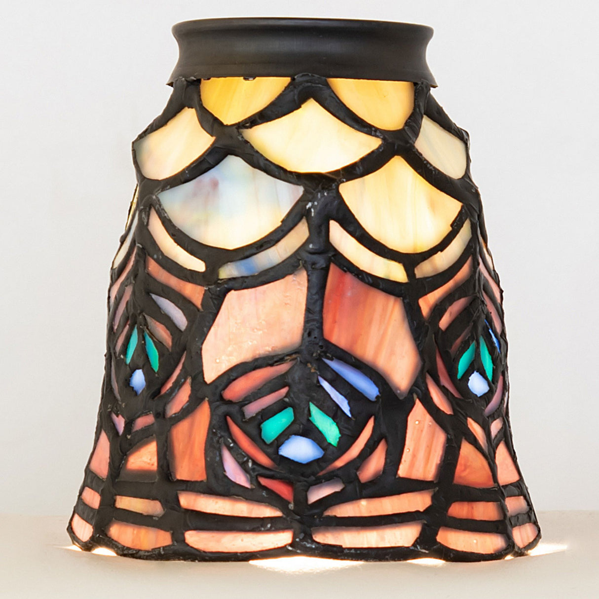 Beautiful Tiffany-style peacock feather fan light shade with intricate details.