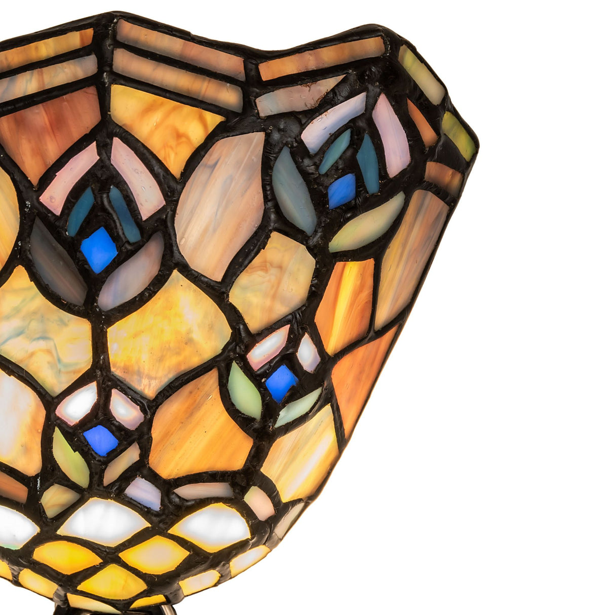 Close-up of intricate stained glass detail on Tiffany peacock night light.