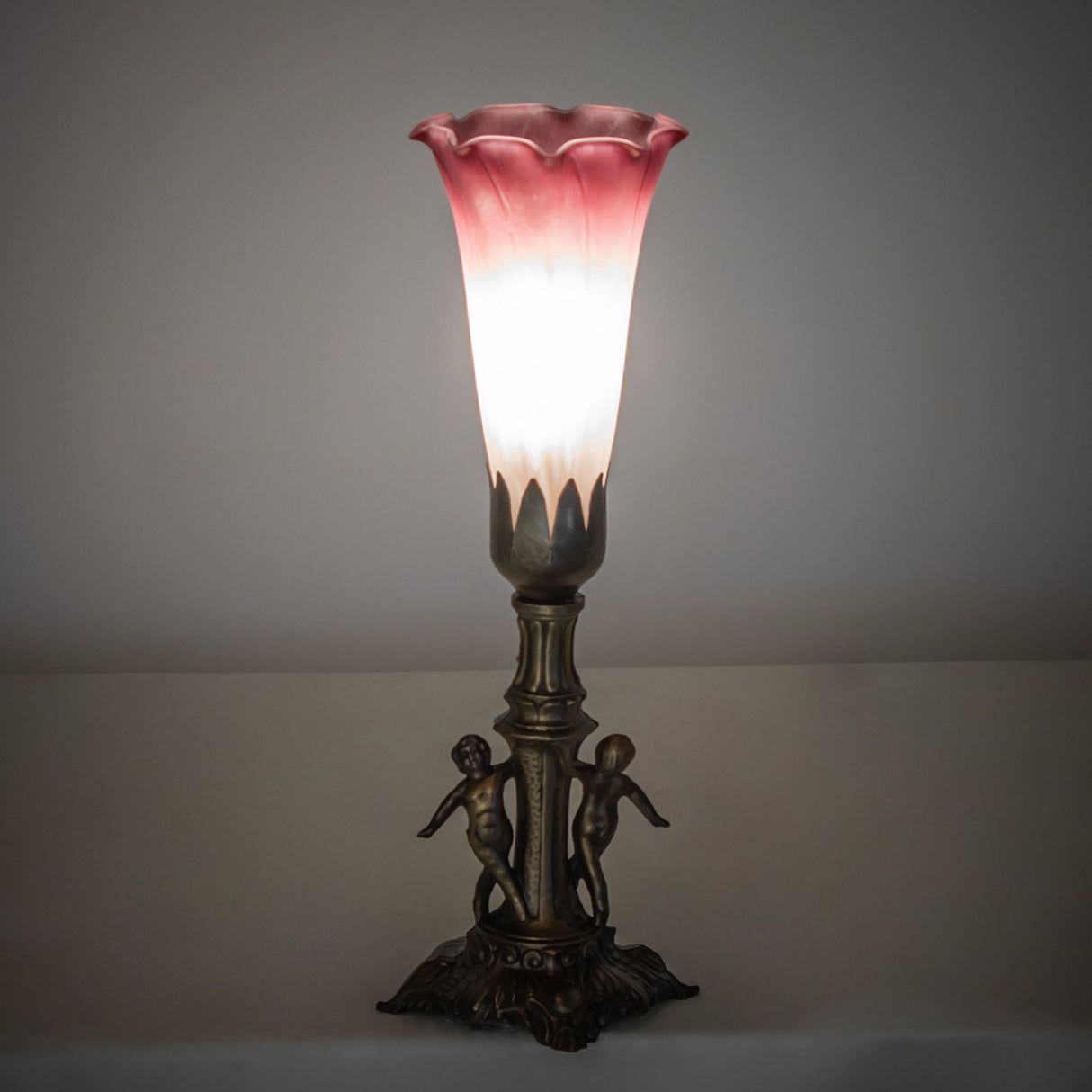 Ambient view of the Tiffany Pond Lily Maidens Mini Lamp, showcasing its warm illumination.