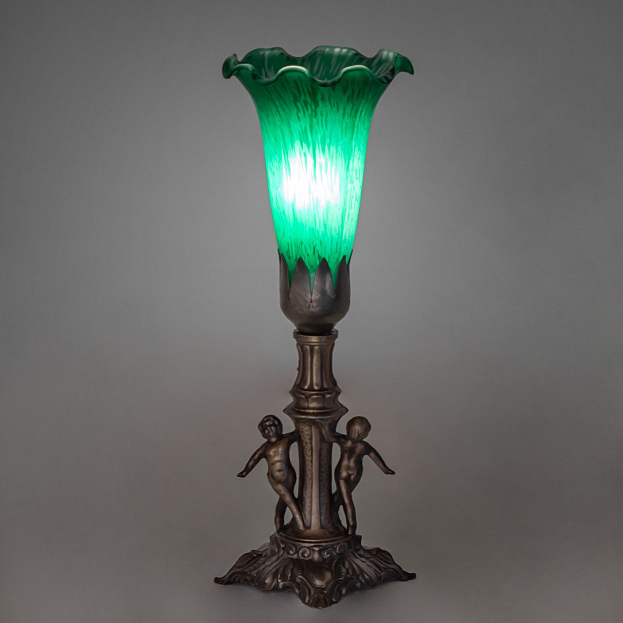 Tiffany Pond Lily Maidens Mini Lamp glowing beautifully in an atmospheric setting.